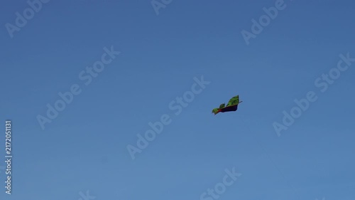 Colorful kite flying high in a clear blue sky