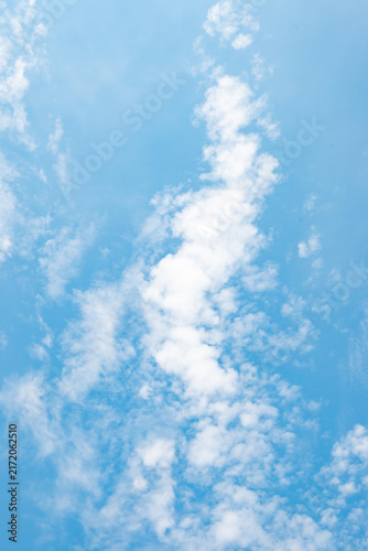 Photography Dreamy summer skyscape with soft white cumulus clouds drifting across a clear bl
