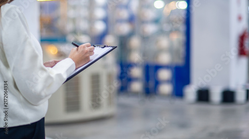 Quality Control Inspector Writing on Clipboard in Textile Factory