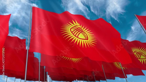 Multiple Kyrgyzstan flags seamless looping waving on blue sky