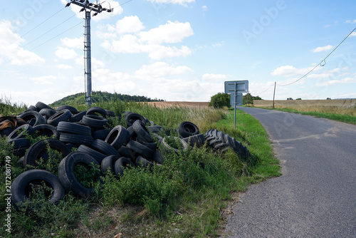 Illegal used car tyre dumping site near road, Czechia