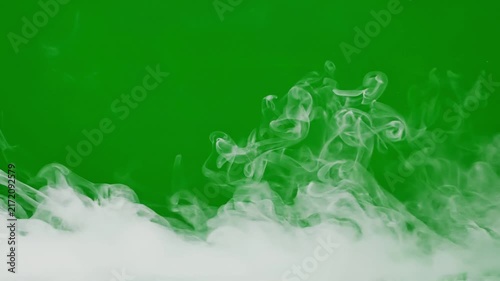 White smoke swirling along bottom on green screen background chroma key vfx element.