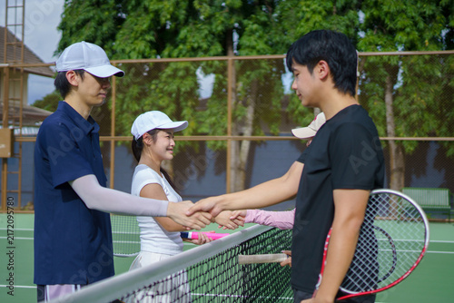 Obraz na plátne Young Asian tennis players exchange friendly Shaking Hands Over Net after a doub