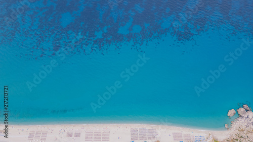 Photography Aerial perspective of a beautiful beach in Lefkada, Greece, showcasing sun loung