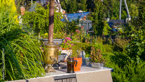Bild auf Leinwand Vibrant, sun-drenched garden scene featuring vintage brass samovar and French pr