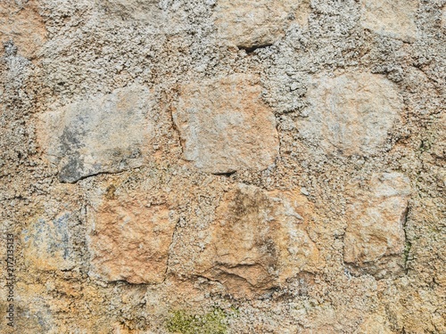Bild auf Leinwand Weathered stone wall with rough textured surface