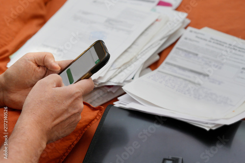 Person using smartphone paying bills and managing finance