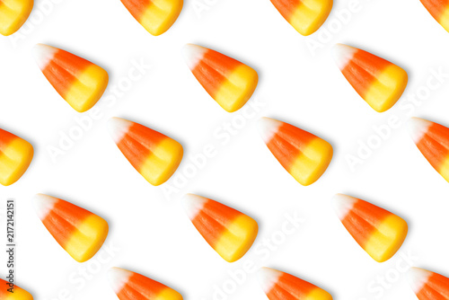 Repeating seamless pattern of candy corn pieces on transparent background