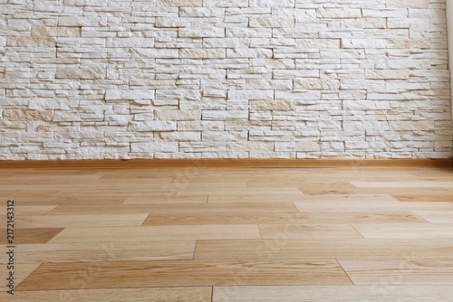 The Wooden Floor in a Minimalist Room Featuring White Stone Wall