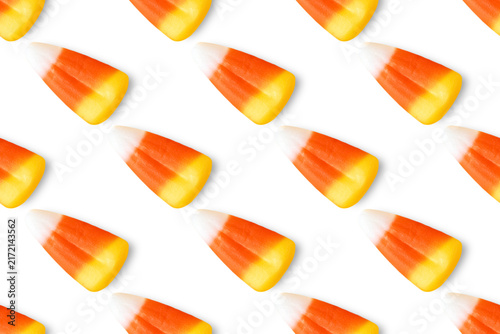 Repeating seamless pattern of candy corn pieces on transparent background