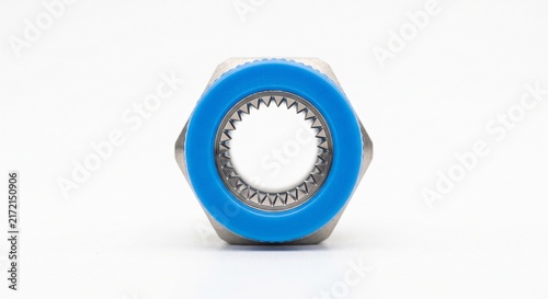 Macro view of internal grip ring in a pneumatic push-to-connect fitting. Stainless steel teeth and blue polymer release collar for fluid power automation.