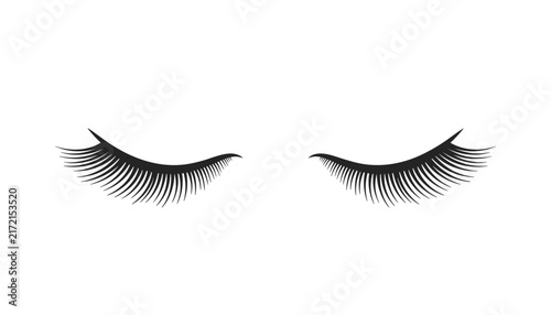Beautiful set of long, dramatic closed black eyelashes or eyelash extensions isolated on a clean white background.