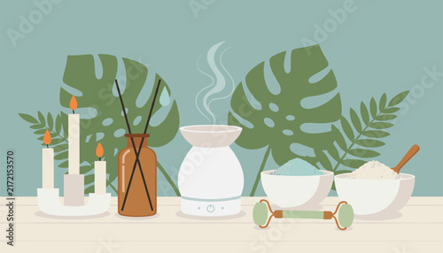 Serene aromatherapy and skincare set featuring lit candles, an oil diffuser, a jade roller, and wellness bowls against leafy background.