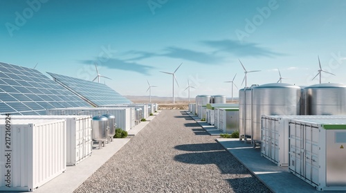 Solar panels and wind turbines powering a modern industrial facility.