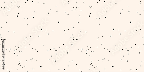 Seamless terrazzo texture with black confetti chips on white background. Simple monochrome pattern with small speckles, particles. Abstract modern texture for wallpaper, package, print, surface design