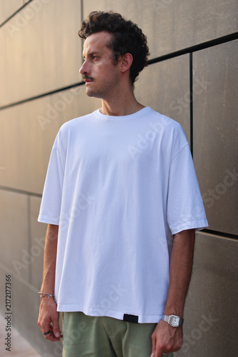 Blank white oversized t-shirt mockup on a young male model, urban street style apparel template
