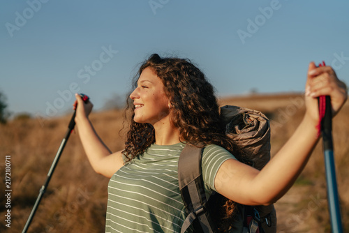 Woman hiking in nature feeling freedom and happiness