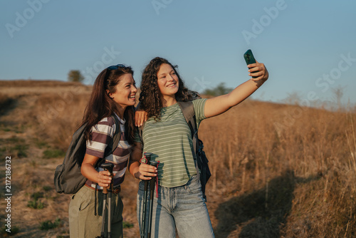 Two women taking a selfie while hiking outdoors