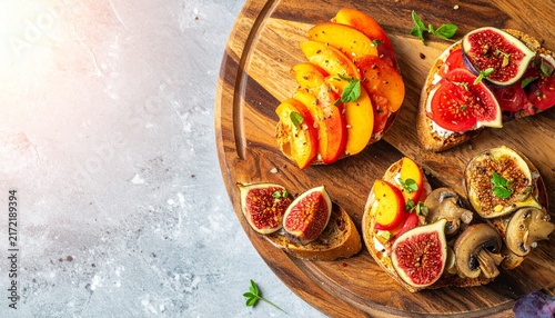 Fresh figs and peaches on rustic wooden board.