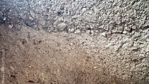 Close-up of rough gray concrete and gravel texture