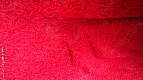 Close-up of bright red plush and fluffy fabric texture