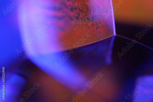 Cuadro en lienzo Luminous violet liquid facet junction with cobalt blue flare and orange micro texture