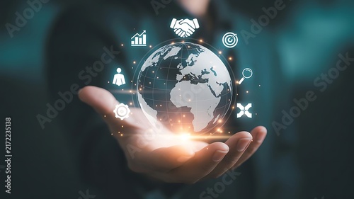 Human hand holding a glowing global network sphere, surrounded by abstract business and technology icons, representing interconnectedness, digital innovation, and future growth opportunities