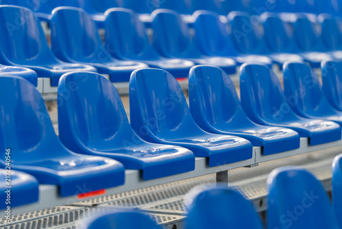 Obraz na plátne Vibrant blue bleacher seats stand ready for cheering crowds during an exciting s
