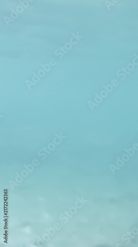 Vertical underwater scene with lone fish in deep blue open water, minimal composition, 4K