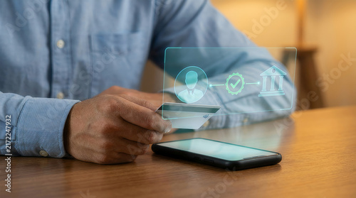 Man holding smartphone with digital banking verification interface