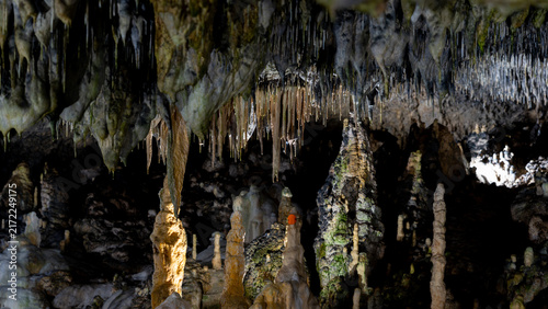 Bild auf Leinwand Stalactites and stalagmites inside a dark limestone cave