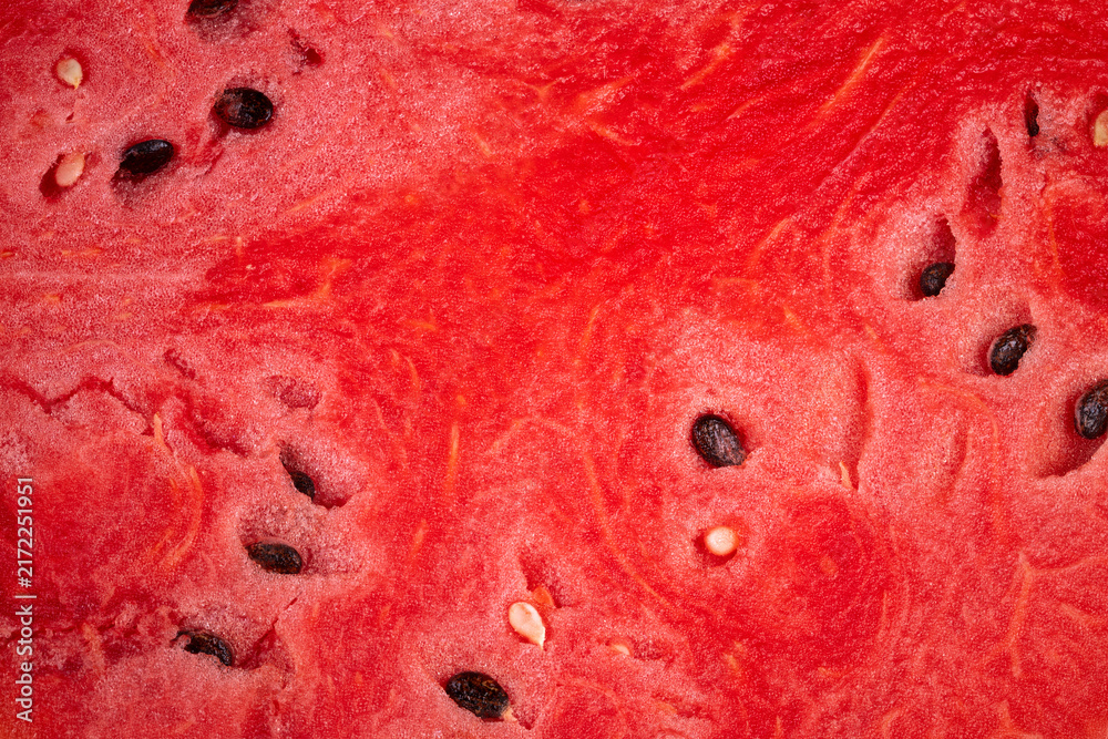 Naklejka premium Slices of juicy watermelon reveal vibrant red flesh and scattered black seeds perfect for summer enjoyment