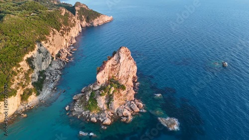 Aerial drone flying above turquoise sea and rocky cliffs in Corfu