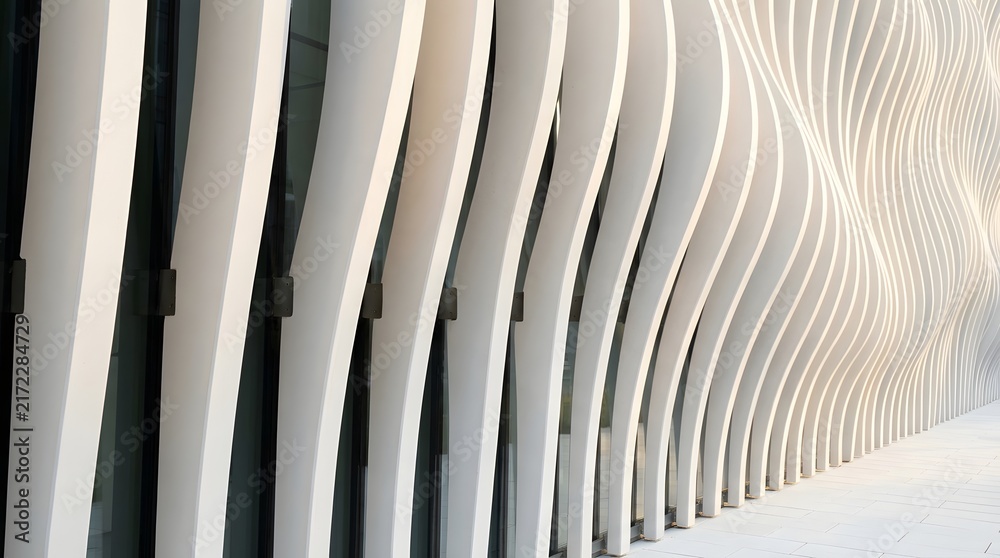 Obraz premium Abstract architectural background with repeating vertical white curved pillars in a modern building interior perspective