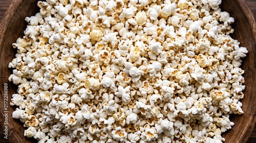 Obraz na plátně Fresh white popcorn in a rustic wooden bowl overhead view