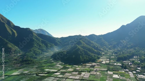 Aerial view of Sembalun valley farmland ringed by mountains with morning haze East Lombok Indonesia