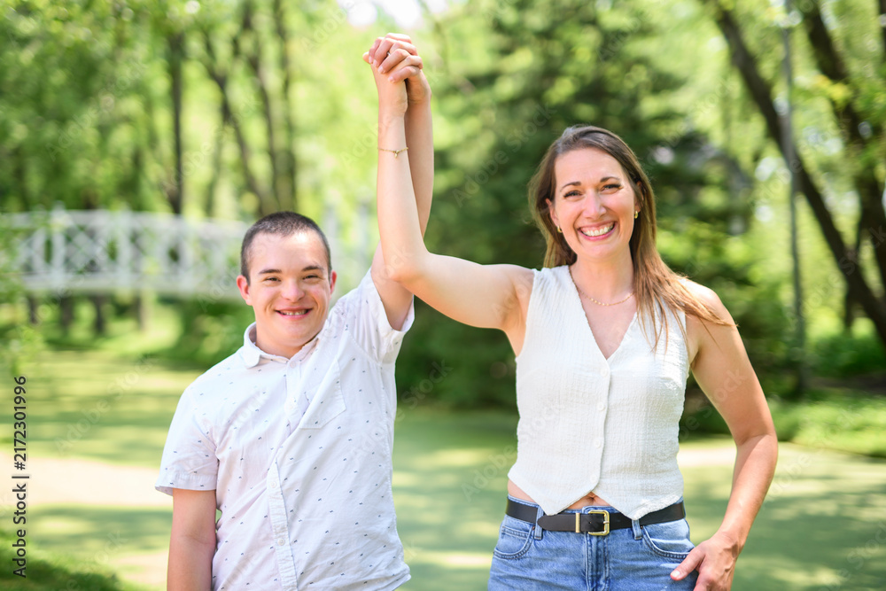 Obraz premium boy with Down syndrome in a park with his mother
