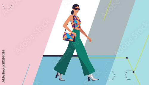 Stylish woman model walking in green wide-leg trousers and a geometric patterned crop top against an abstract colorful background.