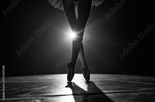 Graceful ballet dancer on stage, en pointe, with dramatic spotlight