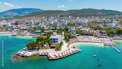 Aerial drone view of Ksamil beach with turquoise water along the coast of the Ionian Sea in southern Albania