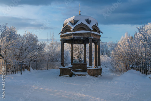 The kivoriy (canopy over the spring of water) in the St. George (Yuriev) on a sunny winter day, Veliky Novgorod, Russia