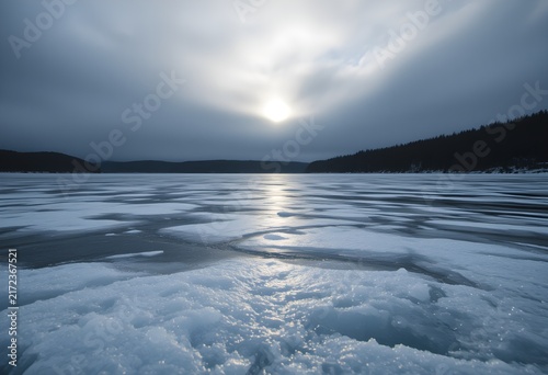 Frozen lake backlit by sun soft diffused overcast sky