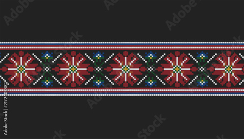 Traditional Slavic geometric embroidery pattern with red flowers and blue details over a dark background.