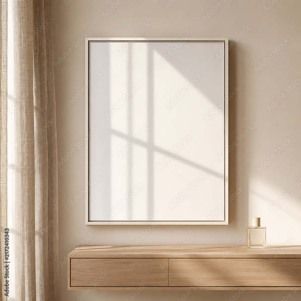 Fototapeta premium White empty frame mockup on minimalist wooden console with soft daylight and neutral interior tones, perfect for artwork placement, branding presentation, poster design, and creative projects.