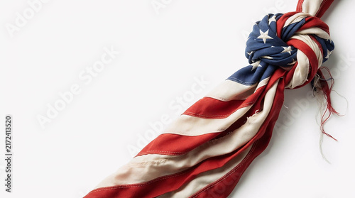 Twisted and knotted vintage American flag with worn texture isolated on white background with copy space, 3D render for USA patriotic, resilience and Independence Day concept design