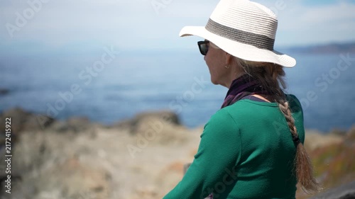 A senior woman enjoys the ocean view while walking on the boardwalk at Mac Kerricher State Park in Fort Bragg, California.