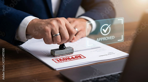 Fototapeta Businessman stamping approved document with digital verification overlay interface