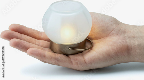 Hand Holding Small LED Lamp with Frosted Glass Globe Isolated on White Background, Modern Portable Night Light for Home Decor, Cozy Lighting and Minimalist Interior Design Concept