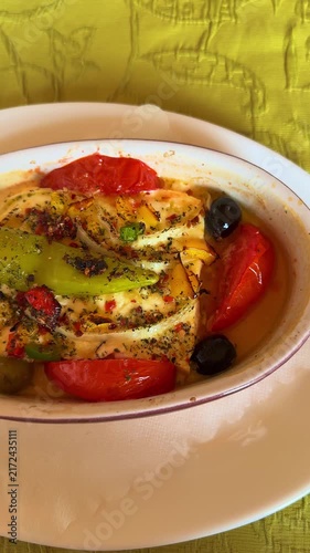 Traditional German style baked sheep cheese with tomatoes peppers onions olives and baguette, vertical video