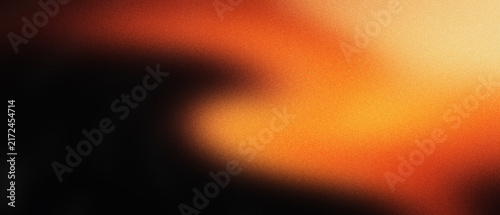 Fotografie Vintage light leak texture with warm orange glow on black background